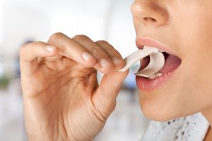 a dental patient chewing sugar-free gum.