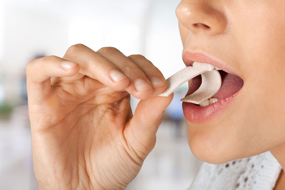 a dental patient chewing sugar-free gum.