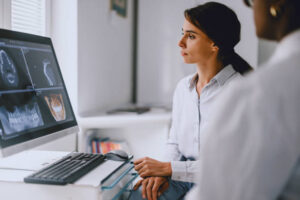 A dentist and patient discussing dental x-rays